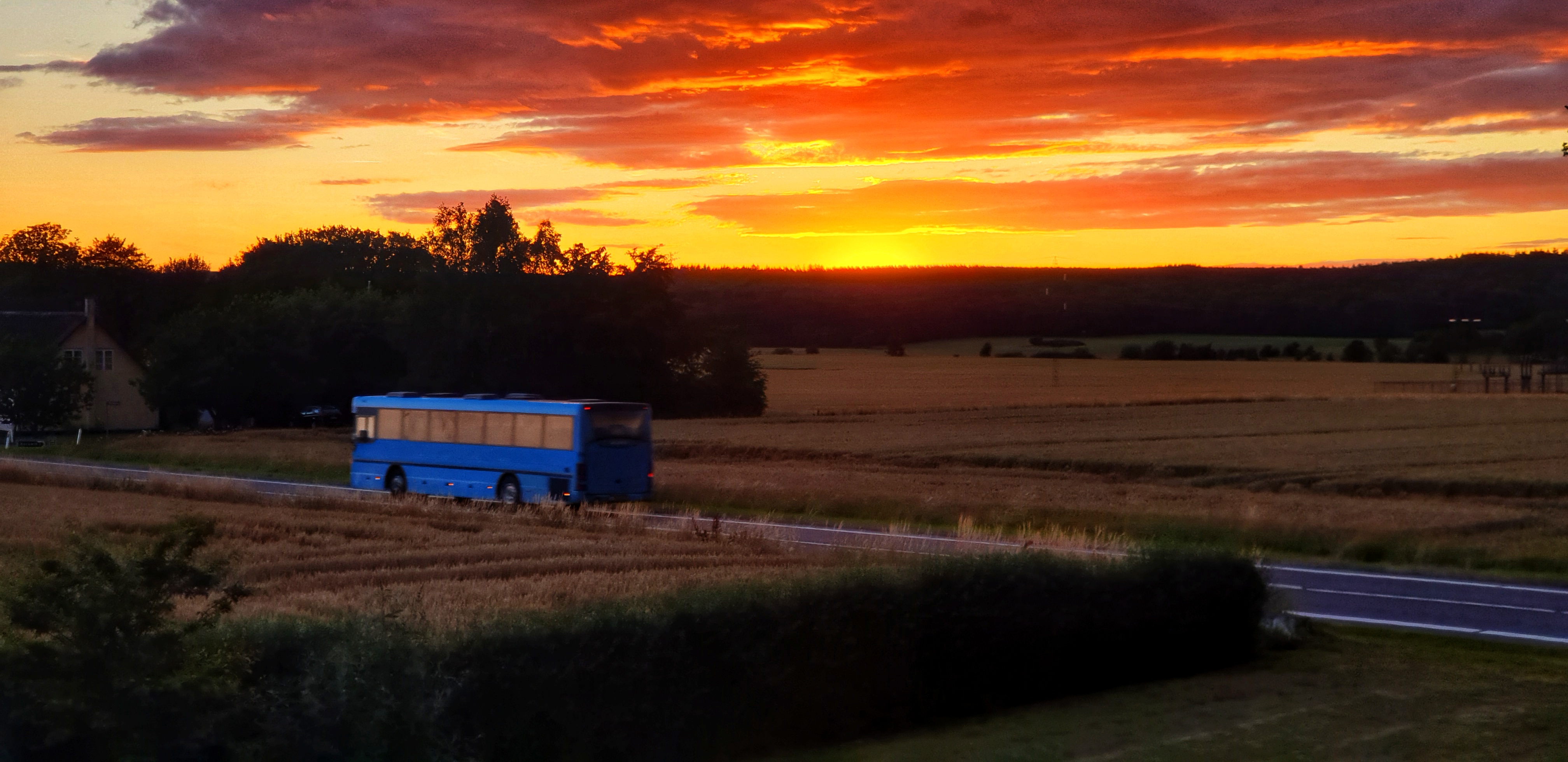 The Blue bus passes our house at sunset